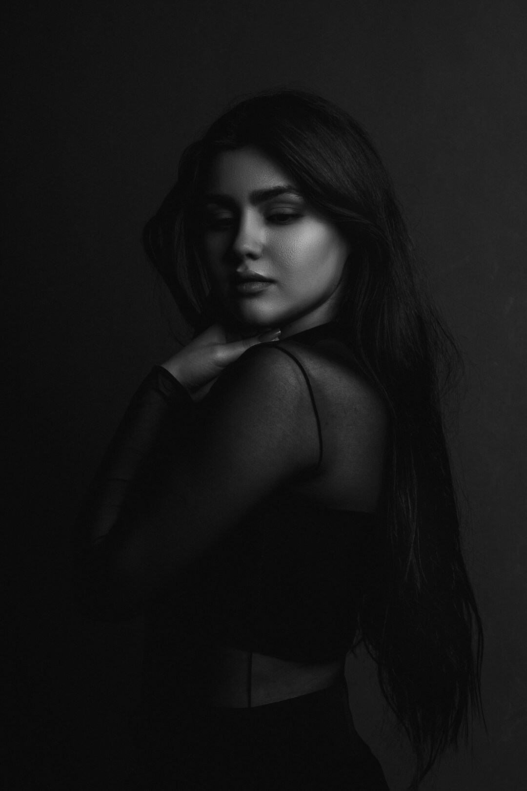 Studio portrait of a woman with long dark hair